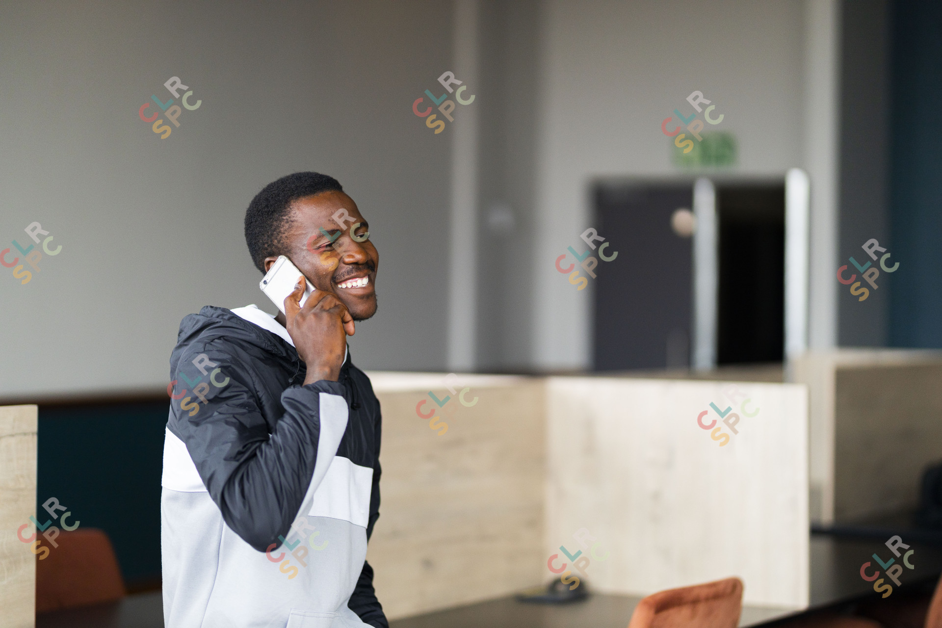 Black man talking on his cellphone at work