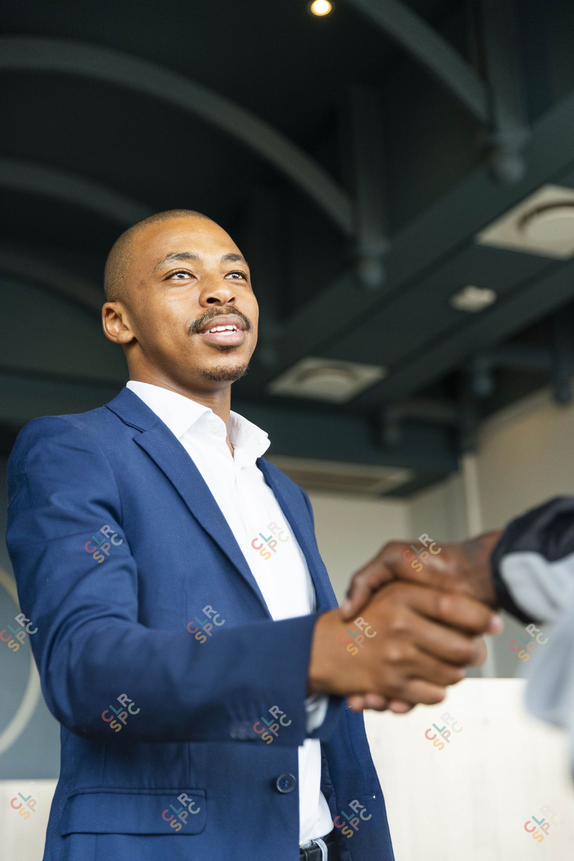 Black business man hand shaking hands with a client at work