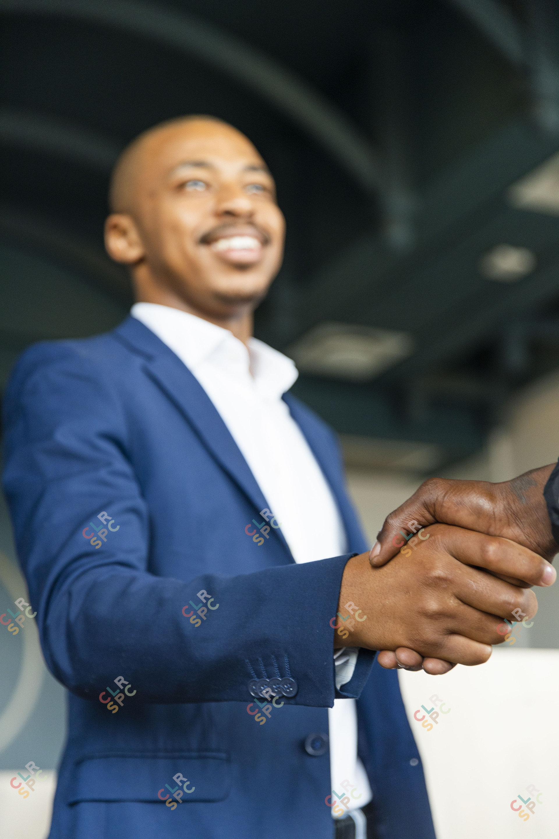 Black business man hand shaking hands with a client at the office and smiling