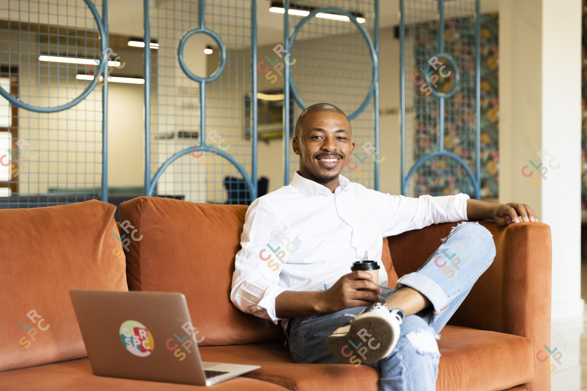 Black business man smiling and looking at the camera at the office