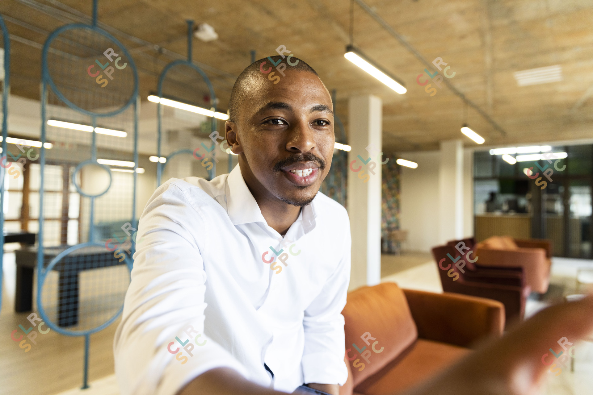 Black business man approaching to shake hands with a client at work