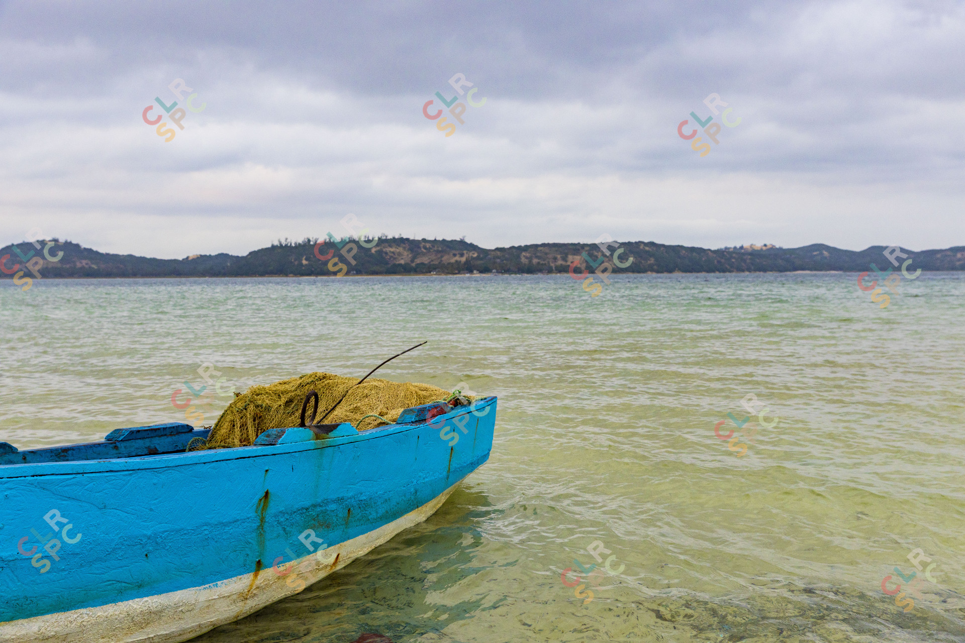 Blue boat docked by a lagoon