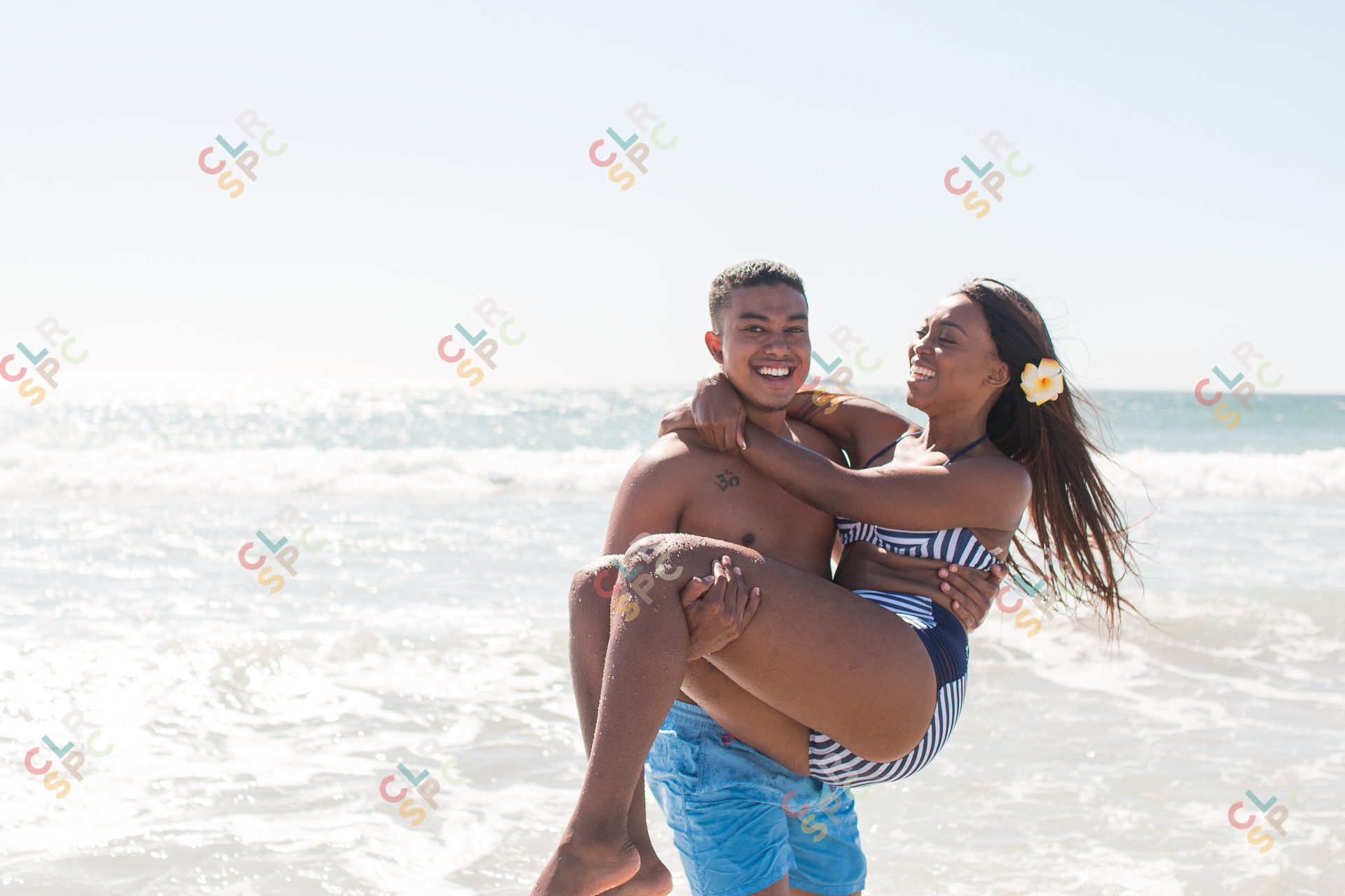 Lovers laughing at the beach