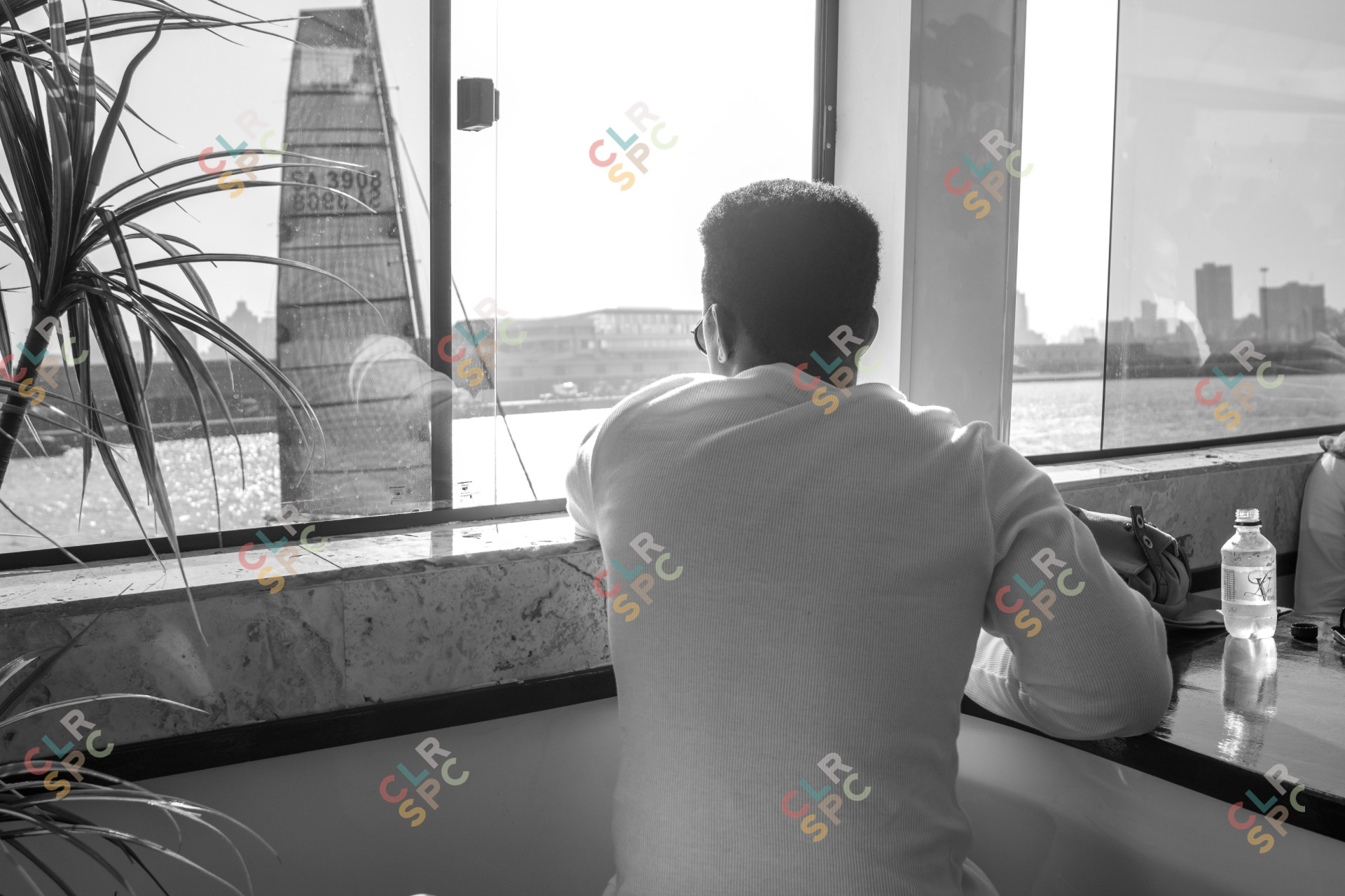 Black man looking over at a boat