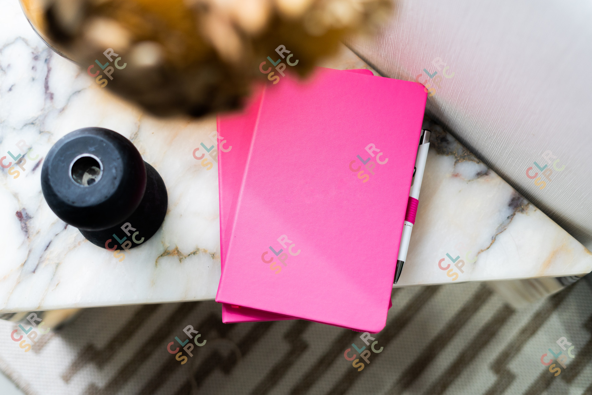 Pink notebooks on a marble table