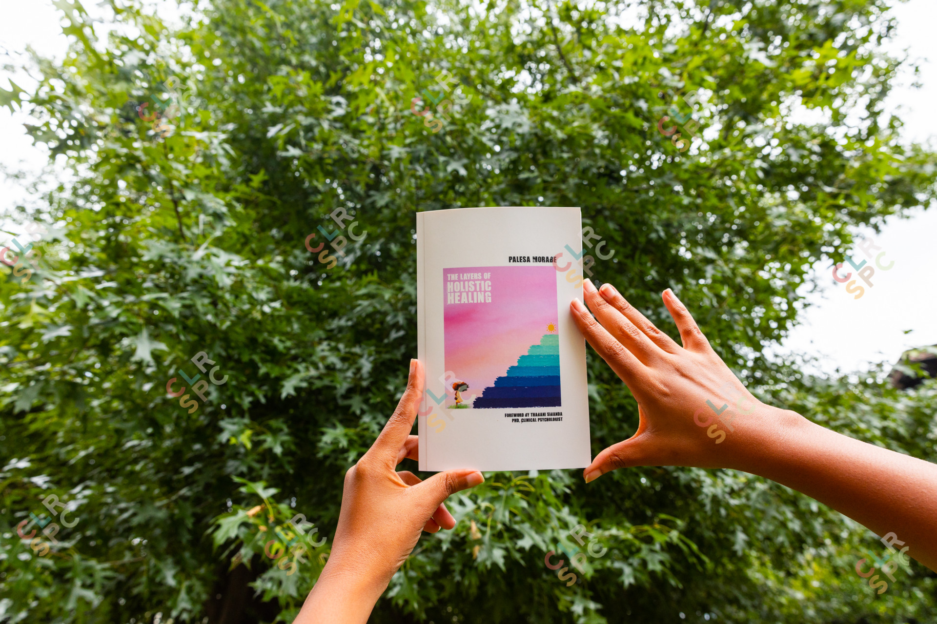 Black woman holding a book about wellness