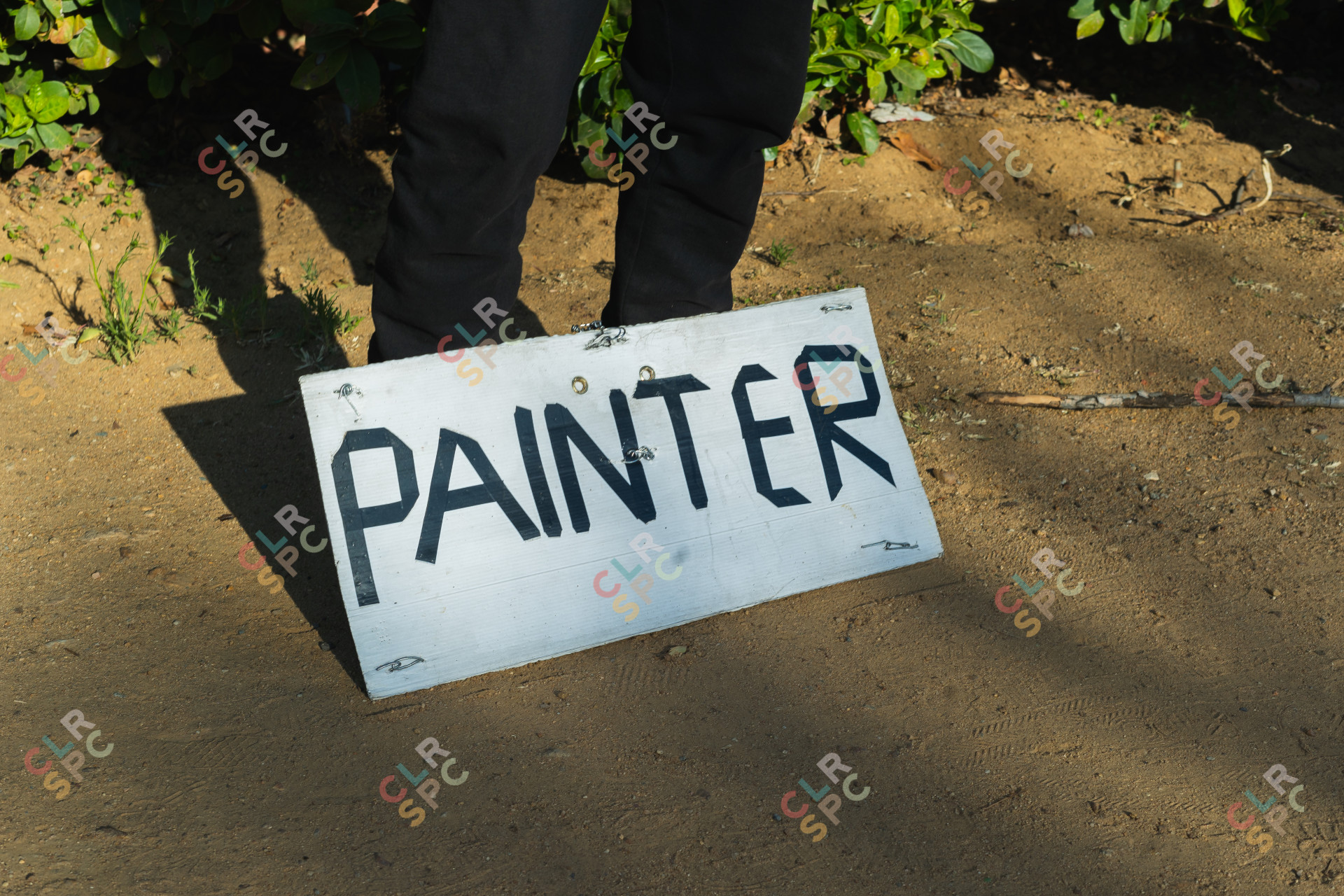 Jobless man holding a painter sign by his feet