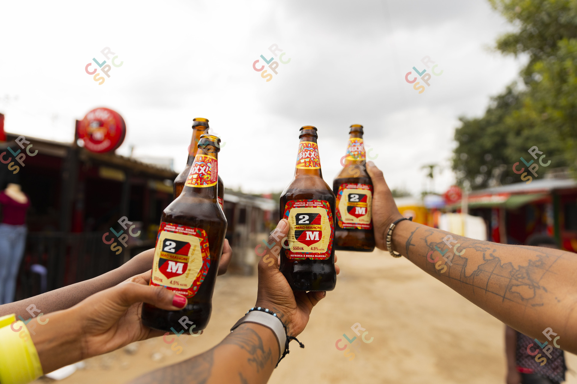 Black hands holding Mozambique beer.