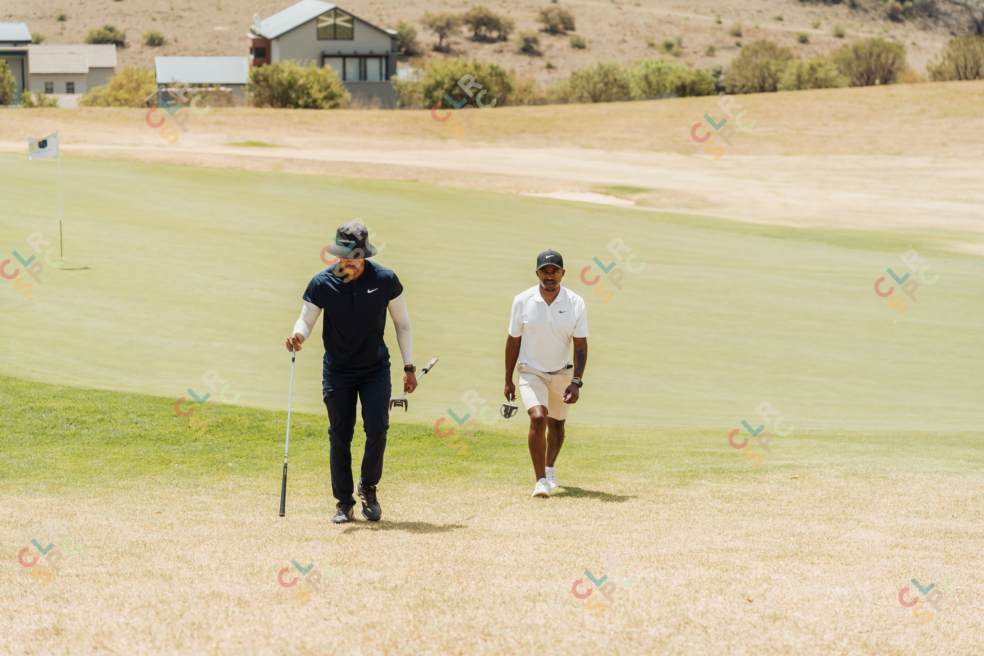 Black male golfers walking to the next hole