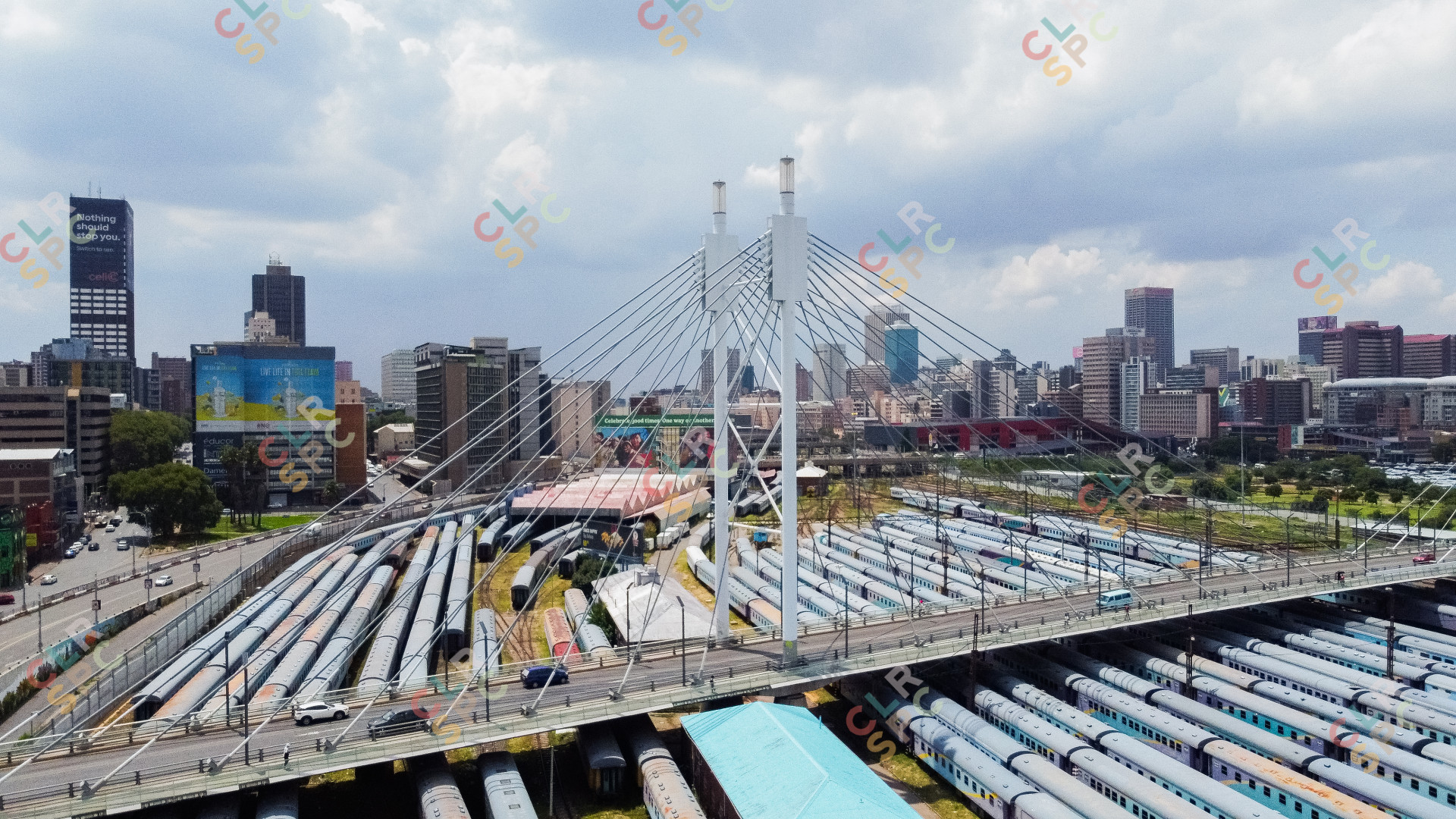 Nelson Mandela bridge from a drone with trains and the city of jozi in the background.