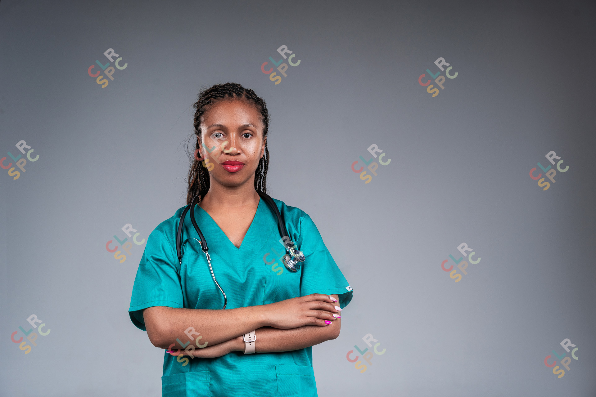 African female doctor wear green lab coat and stethoscope looking at camera.