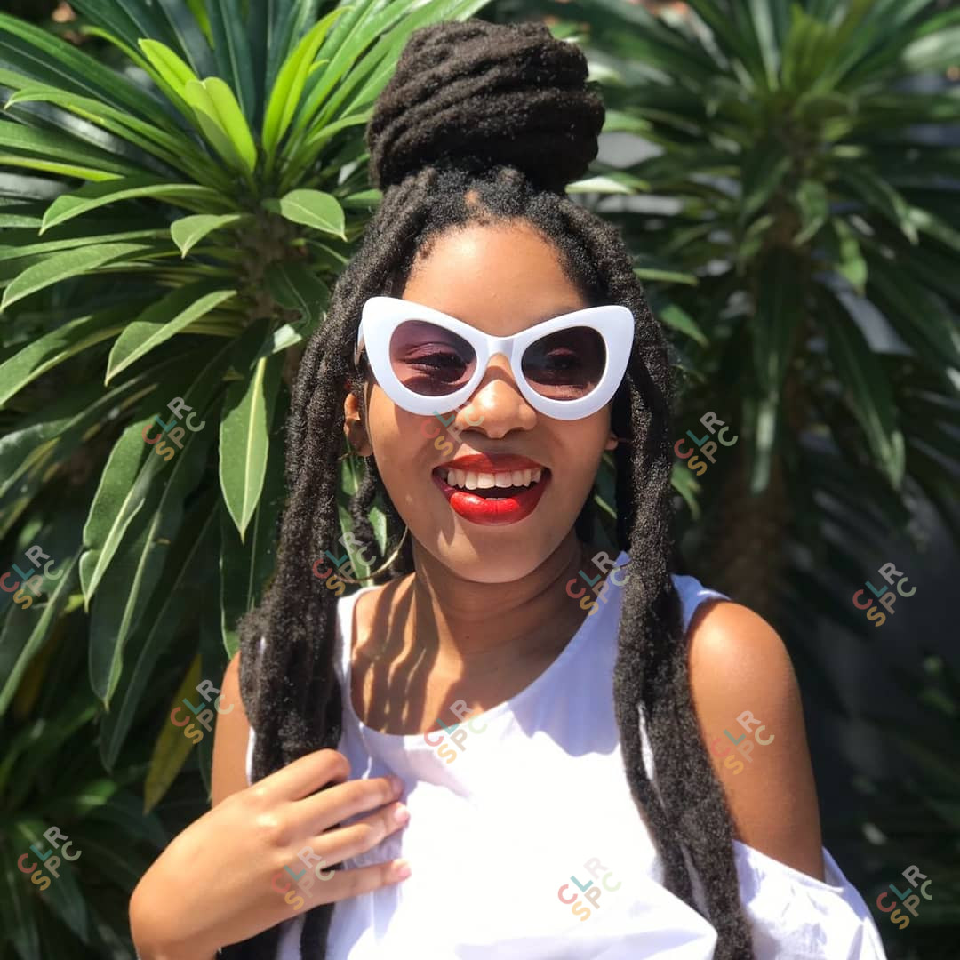 Black woman with white sunglasses smiling