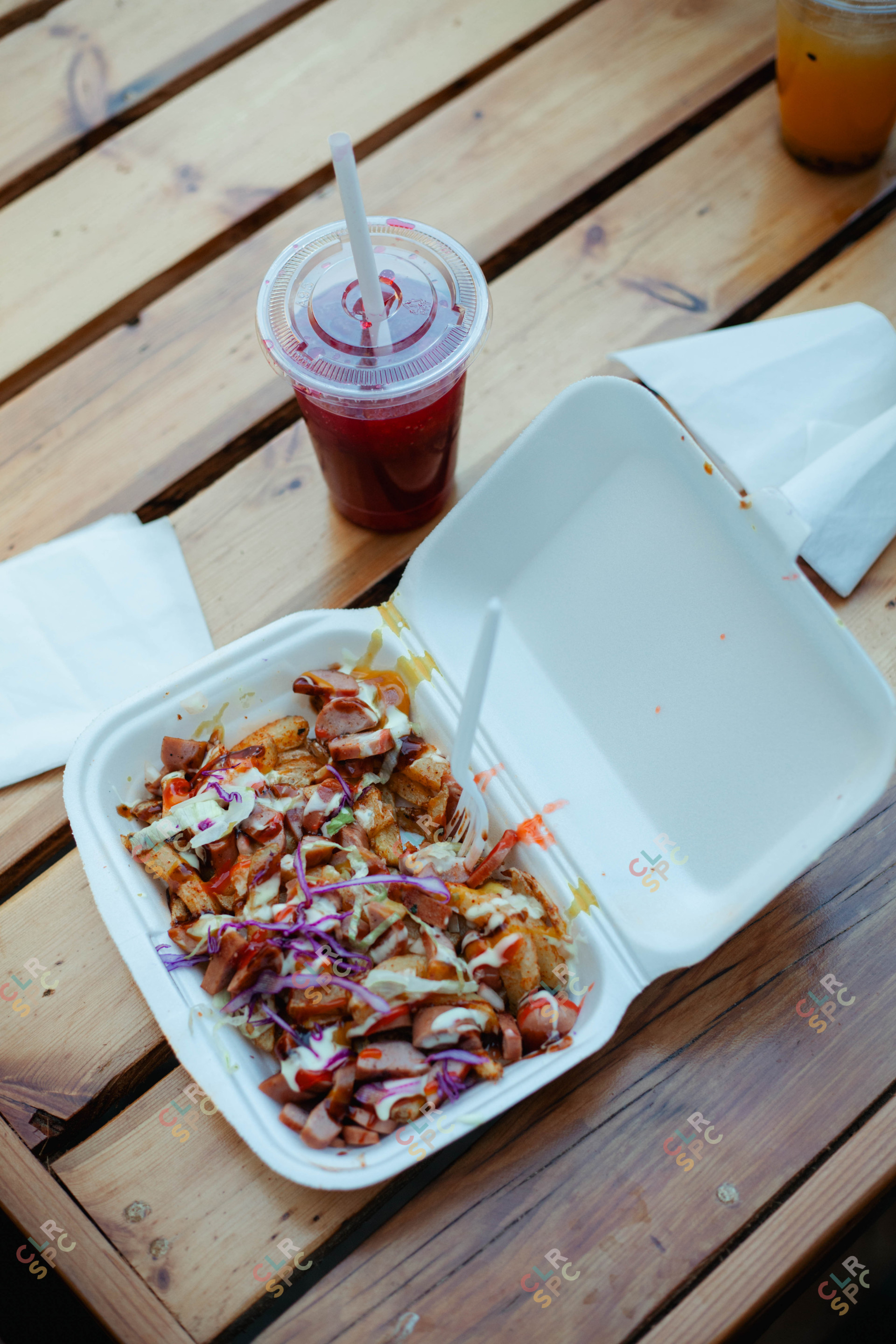 Chips and Russian lunch in a takeaway plate