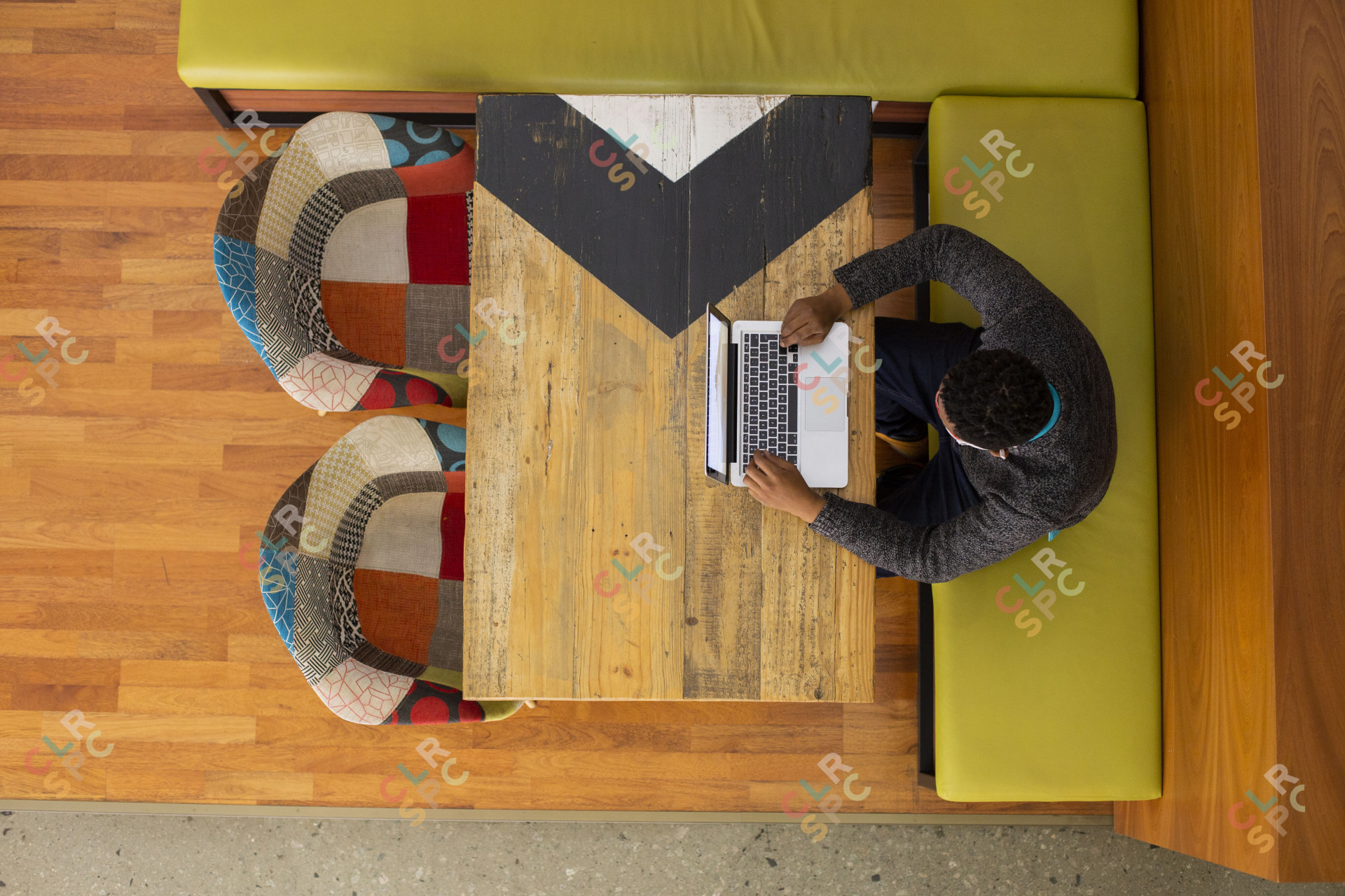 Black man sitting in the office cafeteria working