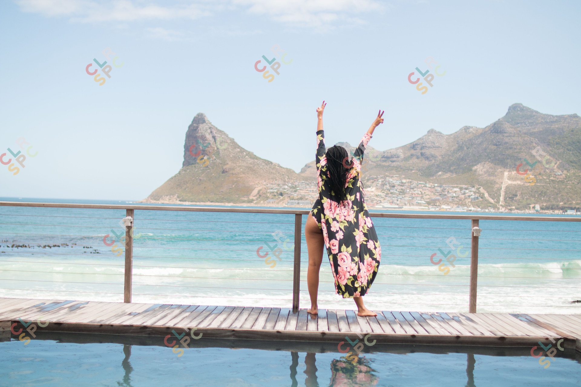 Black woman posing by the ocean in Cape Town