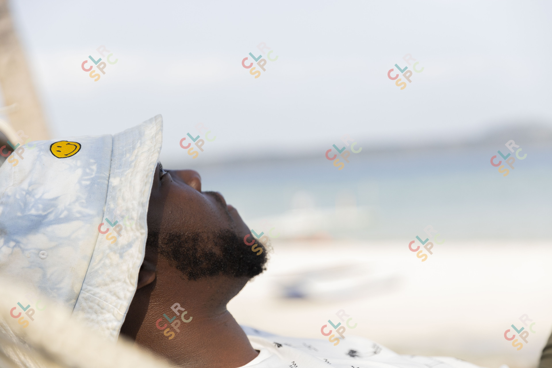 Black man with beard looking up