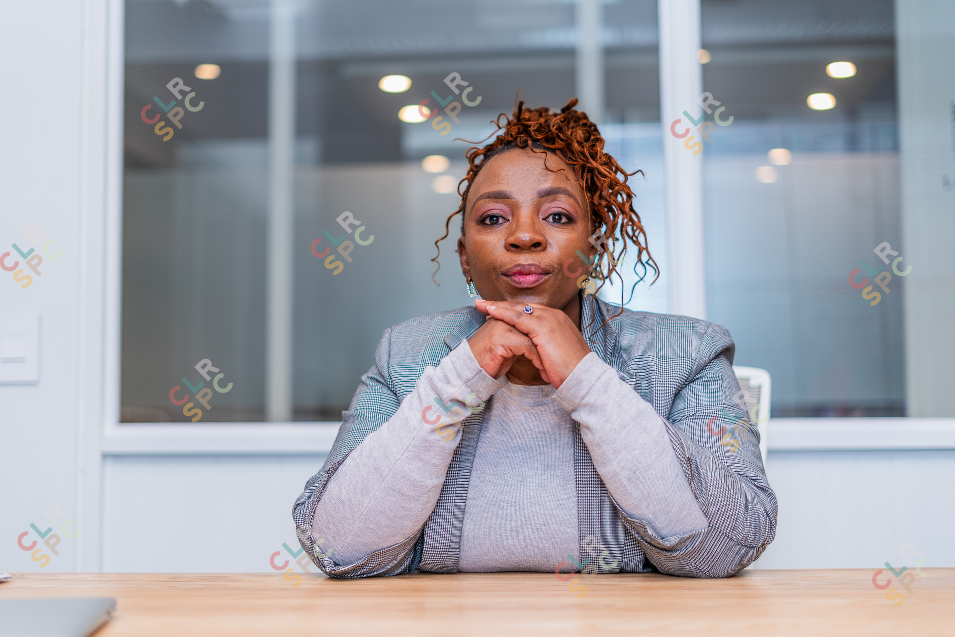 Mature black business woman looking at camera at work.