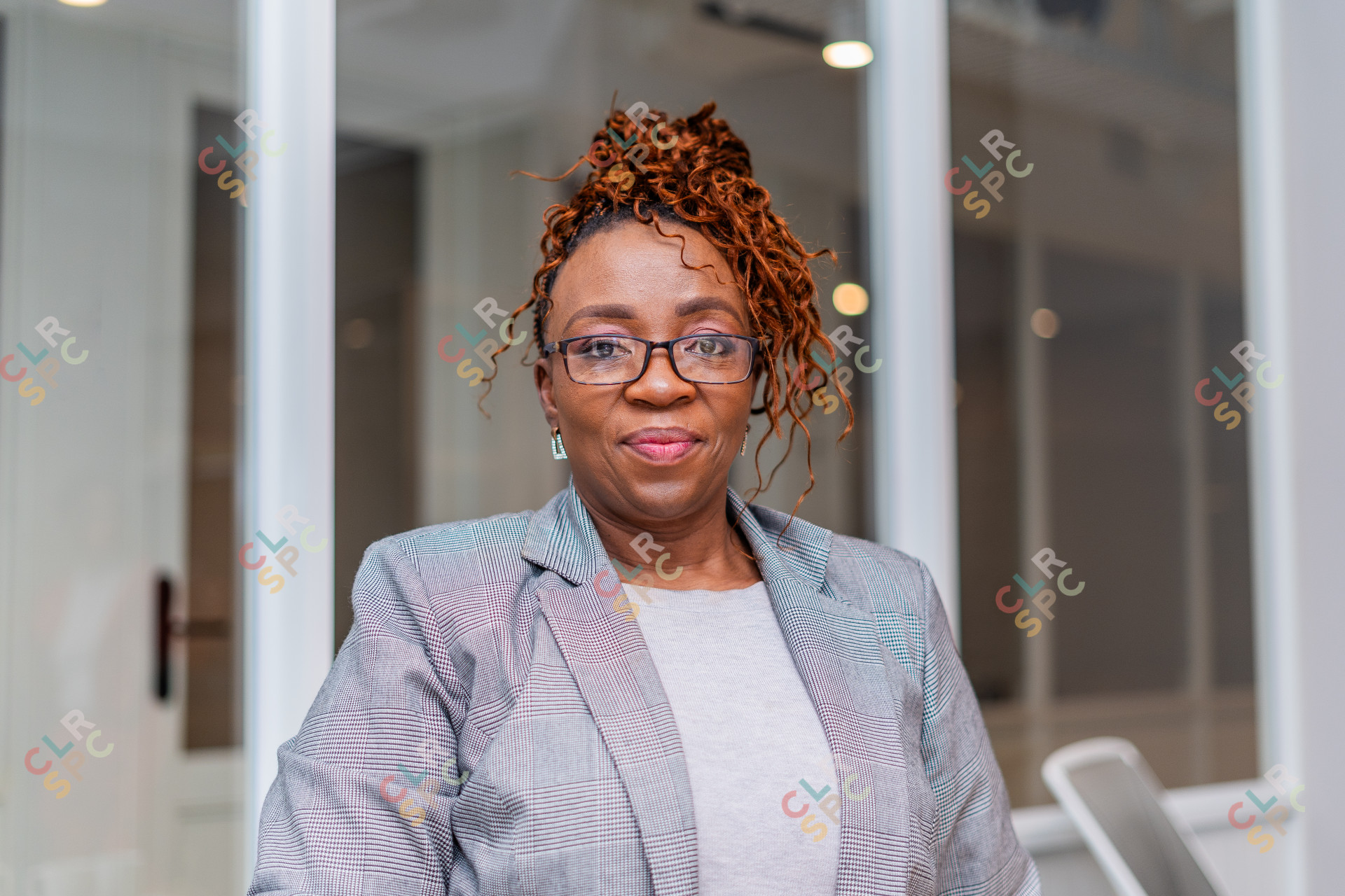 Portrait of mature black business woman at the office wearing glasses.