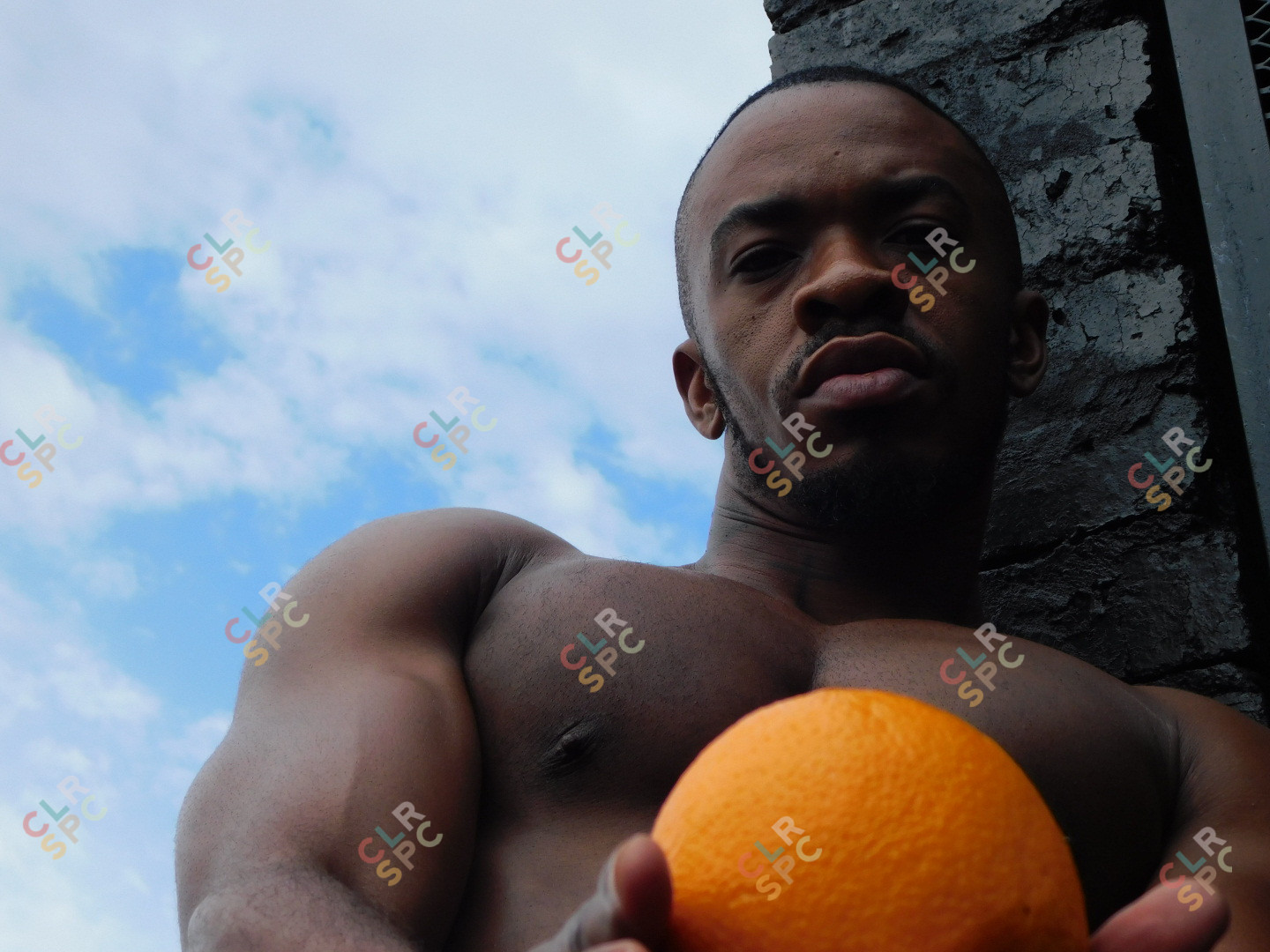 Black man holding  an orange