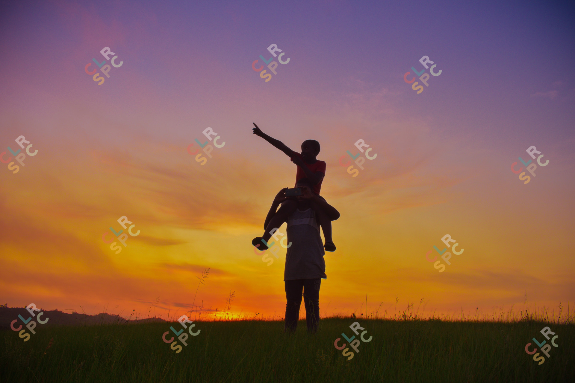 Brothers that look out for each other enjoy the last hour of sunset taking selfies in the mountains