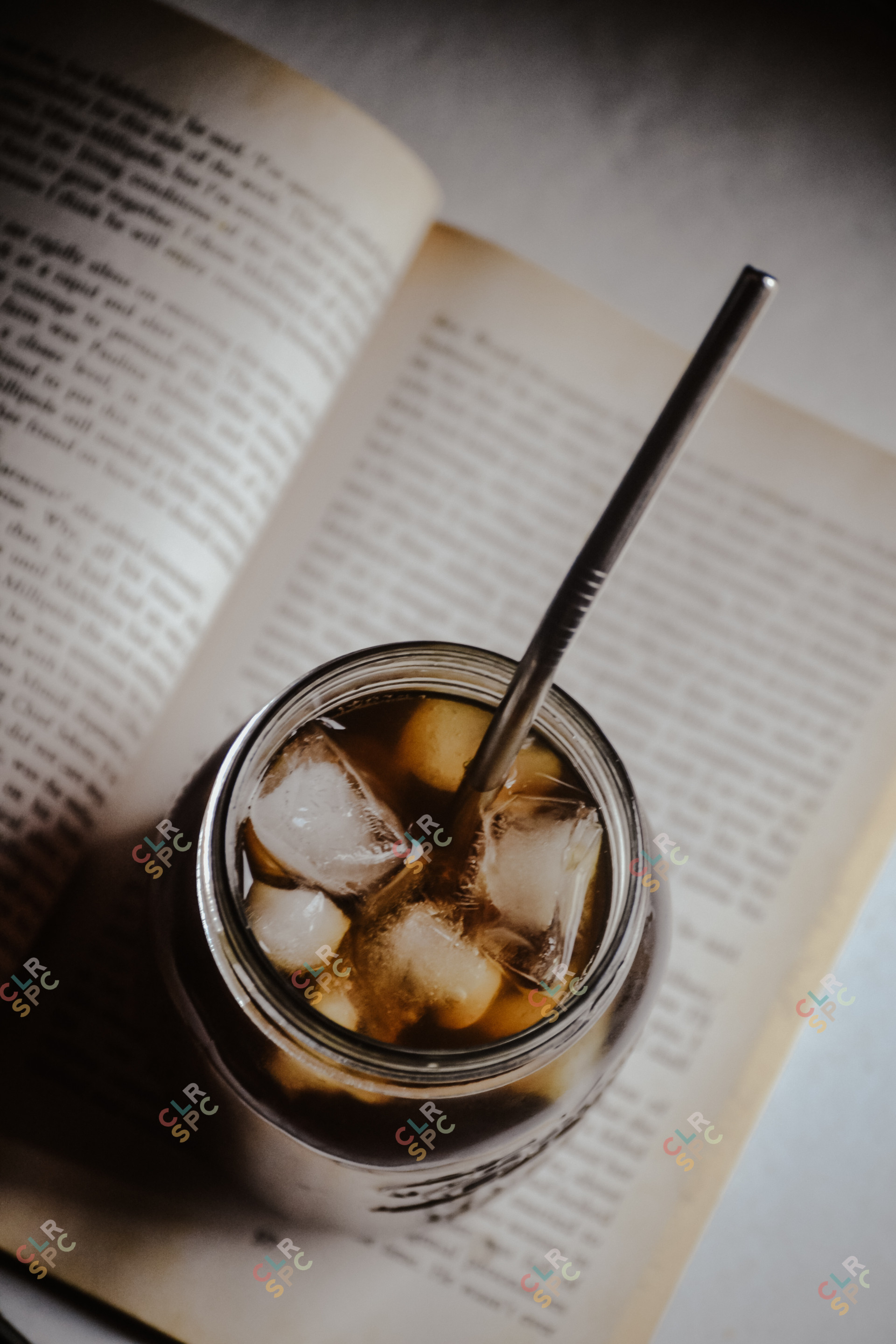Iced coffee on top of a reading book