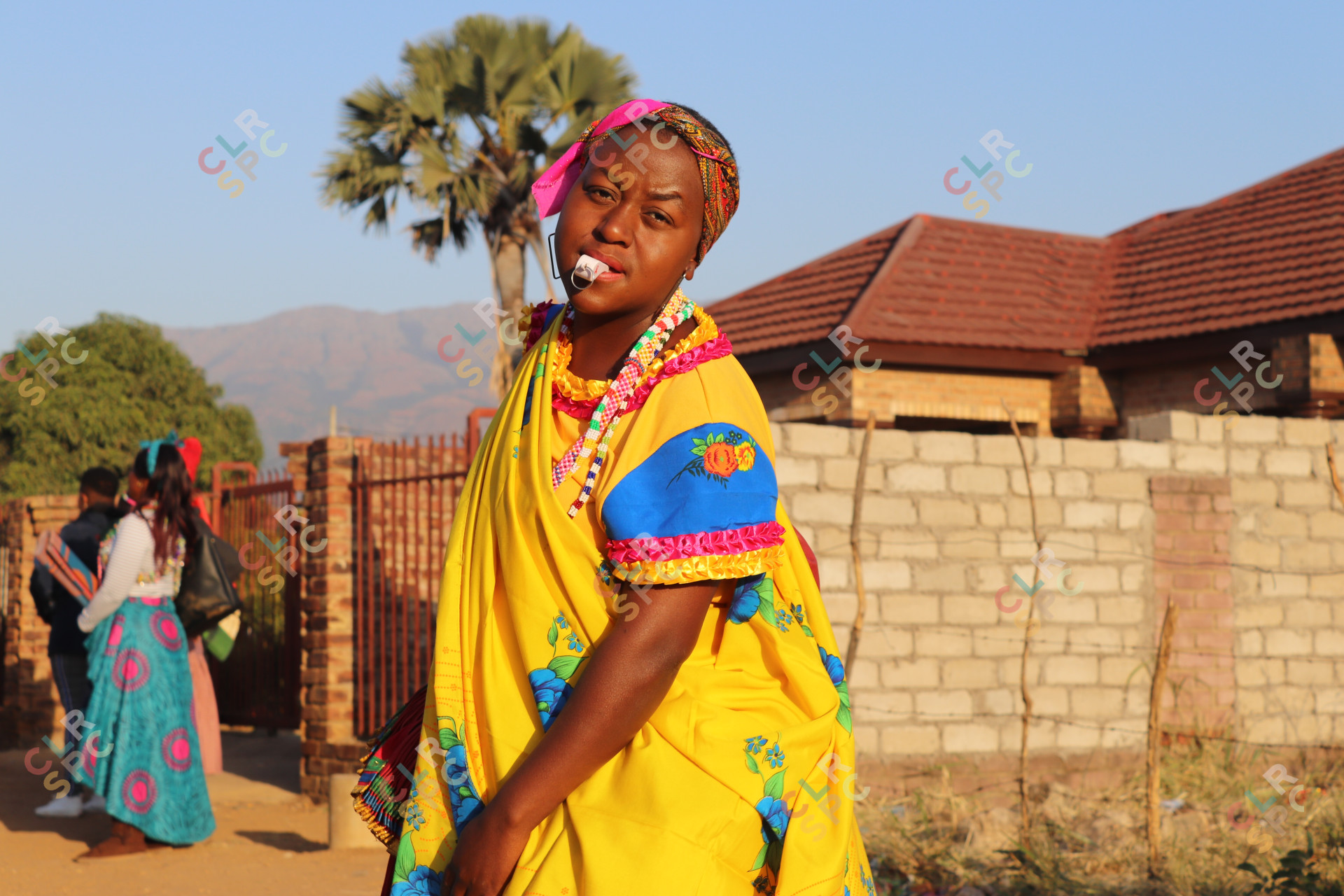Tsonga woman dancing with a whistle in traditional attire