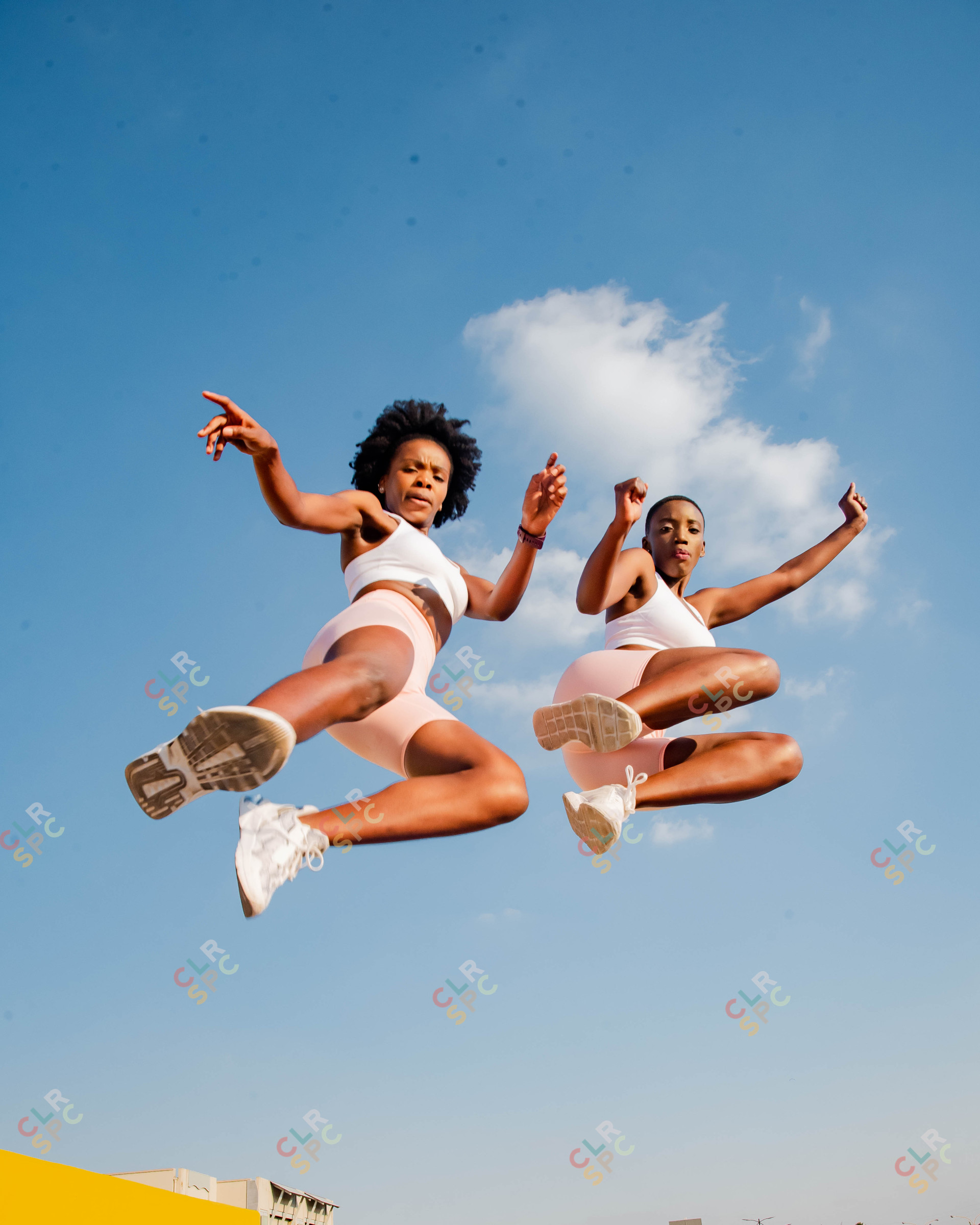 Two black  women exercising on a rooftop