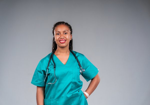 Young female doctor wearing stethoscope smiling at camera.